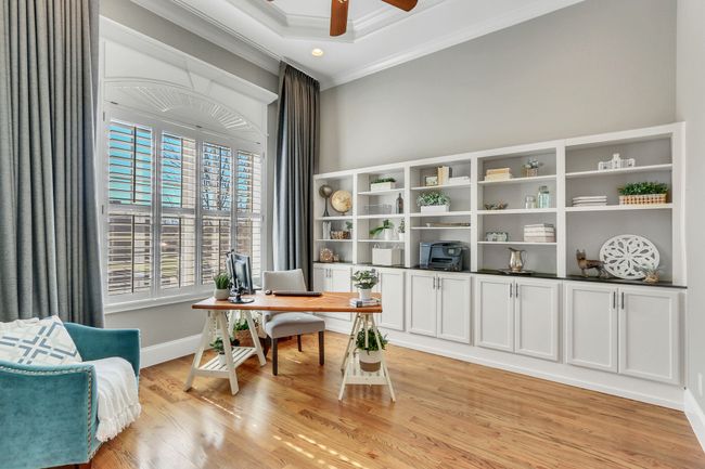The pretty hardwood floors extend to the private, main level office. Bright and cheery with lots of natural sunlight. Yes! Built in cabinets and shelving! | Image 27