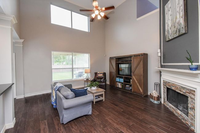 Leading in to your 16' x 20' living room with plenty of windows to let in the soothing natural light on sunny days.Spend time with family around the covered gas log fireplace with modern mantle for all your best family photos. Create new sweet memories while sitting together and watching your favorite films and shows! | Image 11