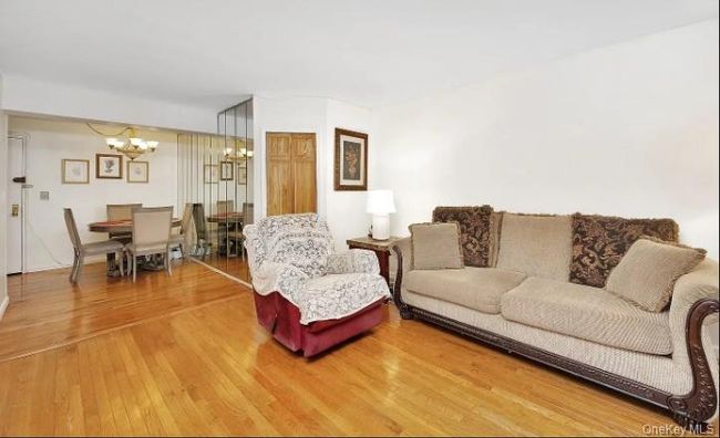 Living room featuring a chandelier and hardwood / wood-style floors | Image 4