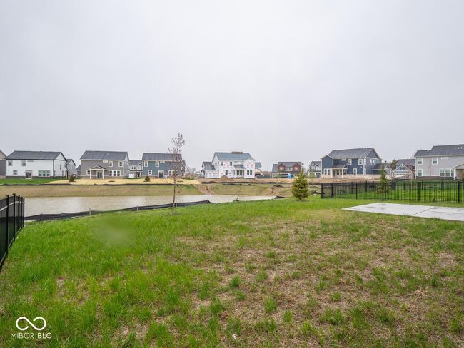 view of yard featuring fence, a residential view, and a water view | Image 55