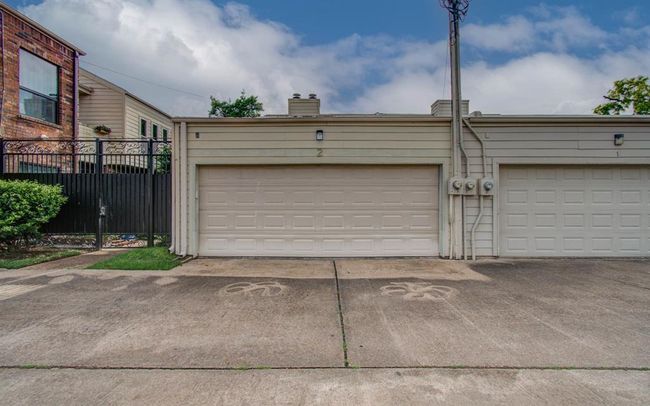 Spacious two-car garage with easy access and secure entry, perfect for storage and convenience. | Image 23