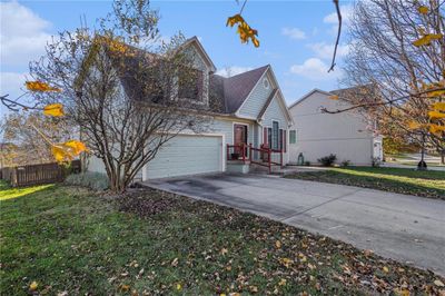 View of property exterior with a garage and a yard | Image 3