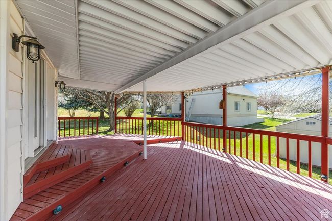Wooden terrace featuring a lawn | Image 33