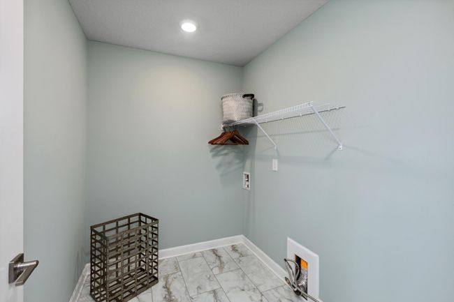Photo is of the actual model. Centrally located on the upper level, along with the four bedrooms, this laundry room is sure to provide the ultimate convenience. | Image 23