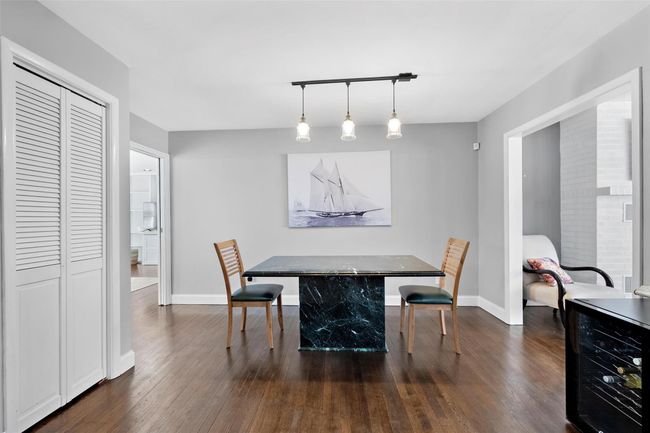 Dining room with wine cooler, dark wood finished floors, and baseboards | Image 12