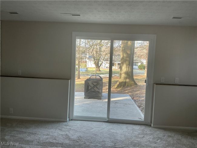 Doorway featuring carpet and a textured ceiling | Image 7
