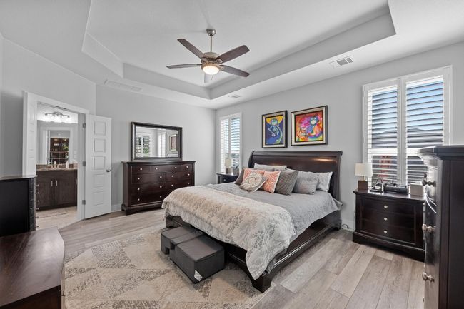 Bedroom with deep carpeting, a tray ceiling | Image 13