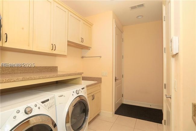 Front-loading washer and dryer make doing laundry less of a chore. The laundry sink is deep which is great for filling buckets. | Image 49