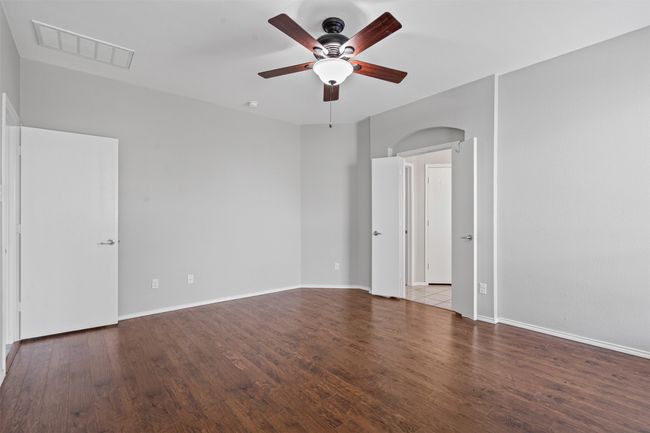 Spare room featuring ceiling fan and wood finished floors | Image 13