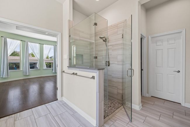 Bathroom with a stall shower and wood finished floors | Image 16