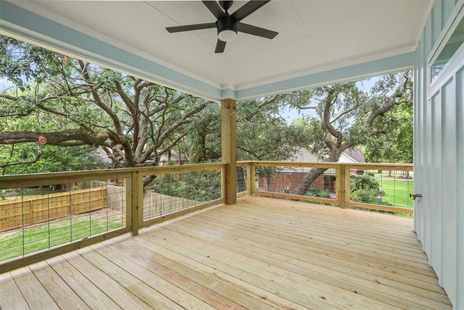 Back upstairs patio, located off of the primary bedroom, which also wraps around to the front | Image 20