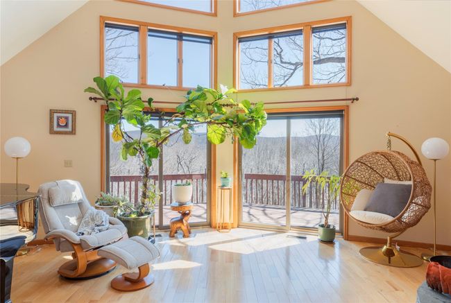 Living area with wood-type flooring, high vaulted ceiling, and a mountain view | Image 5