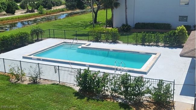 View of community pool with bathrooms | Image 18