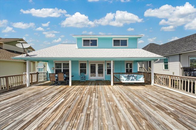 Spacious deck with a porch swing, perfect for enjoying stunning sunsets. | Image 24
