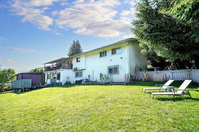 Rear view of property featuring a balcony and stucco siding | Image 16