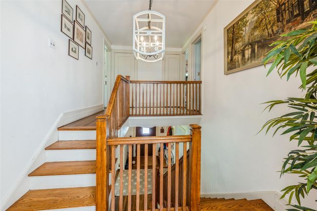 Gracious turned staircase leading to three additional bedrooms and two baths. | Image 19