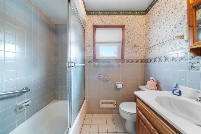 Bathroom featuring wainscoting, tile patterned flooring, tile walls, and wallpapered walls | Image 21