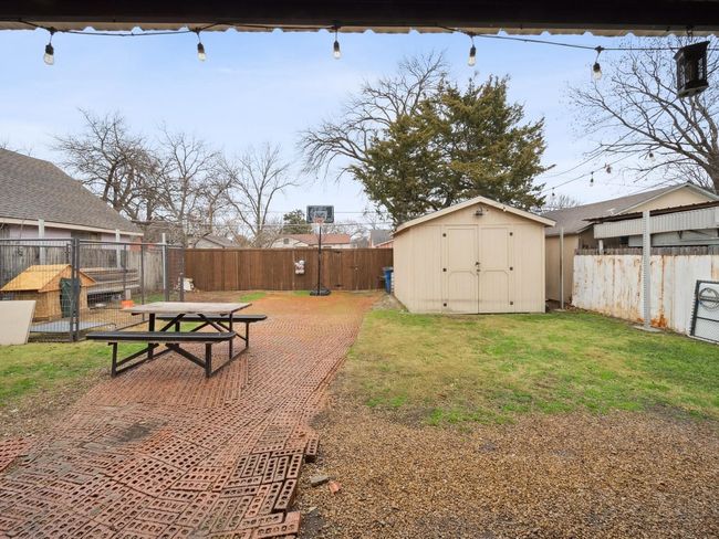 View of yard with a storage shed and an outdoor structure | Image 14