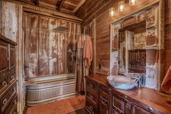 Full bathroom featuring wood walls, shower / bathtub combination with curtain, vanity, and wood ceiling | Image 8