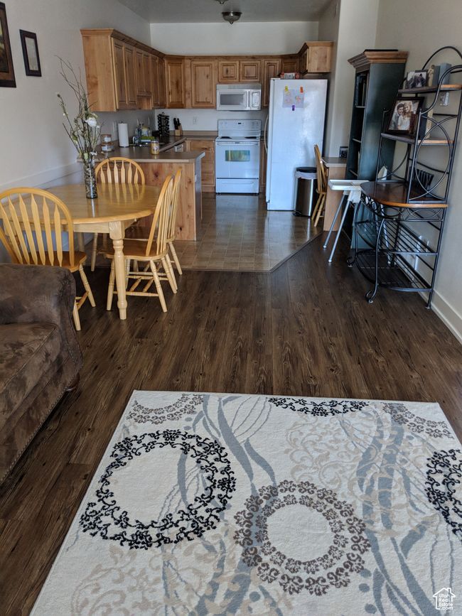 Kitchen with dark wood-style floors, baseboards, and white appliances | Image 5