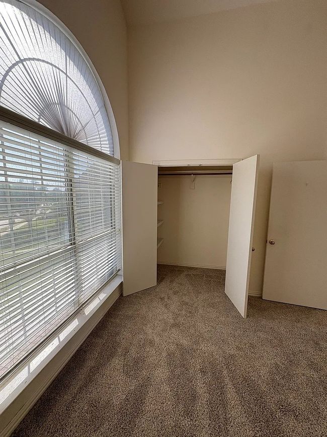 Unfurnished bedroom featuring carpet flooring and a closet | Image 5