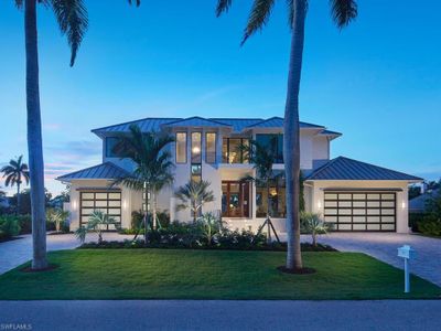 View of front of house featuring a garage and a lawn | Image 1