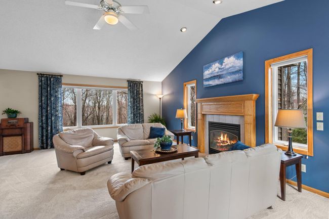 Vaulted living room with fireplace and 'just installed" neutral carpeting. | Image 5