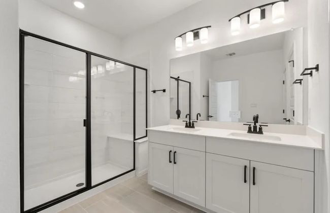 Full bath featuring a stall shower, double vanity, and recessed lighting | Image 5
