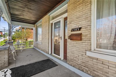 The front porch is perfect for providing shade on those sunny days, or enjoying rain storms. | Image 2