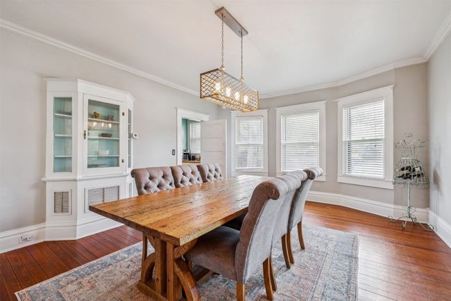 Dining room featuring hardwood / wood-style flooring, ornamental molding, and a chandelier | Image 10