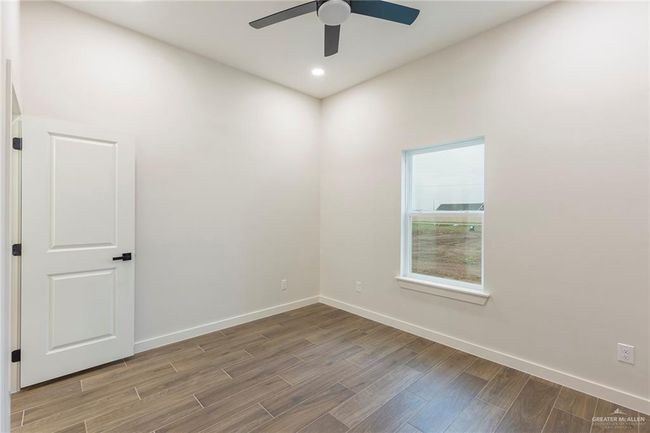 Spare room with ceiling fan | Image 21