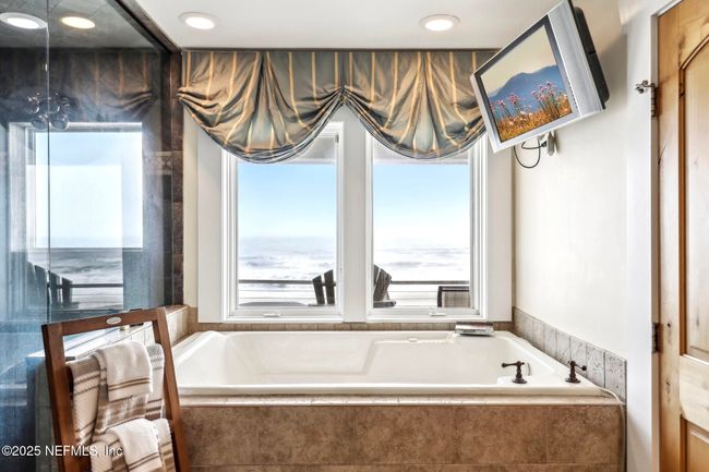 Primary Bathroom with Large tub and window in shower overlooking the beach | Image 18