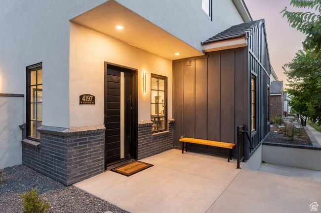 Exterior entry at dusk with a patio | Image 6