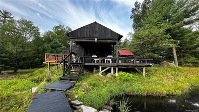 Back of property with a wooden deck | Image 2