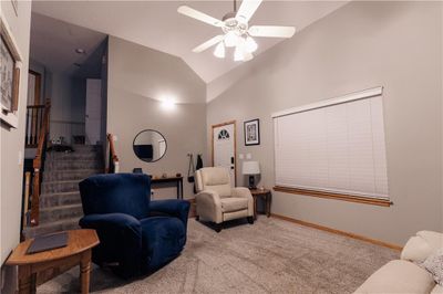 Great room featuring high vaulted ceilings, ceiling fan and carpet | Image 2