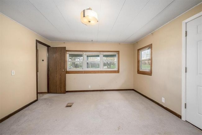 Empty room with carpet floors, a healthy amount of sunlight, and baseboards | Image 21