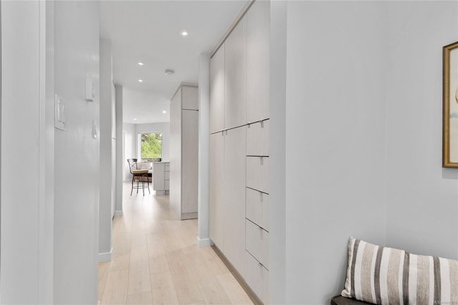 Hallway into the condo with custom build cabinets | Image 18