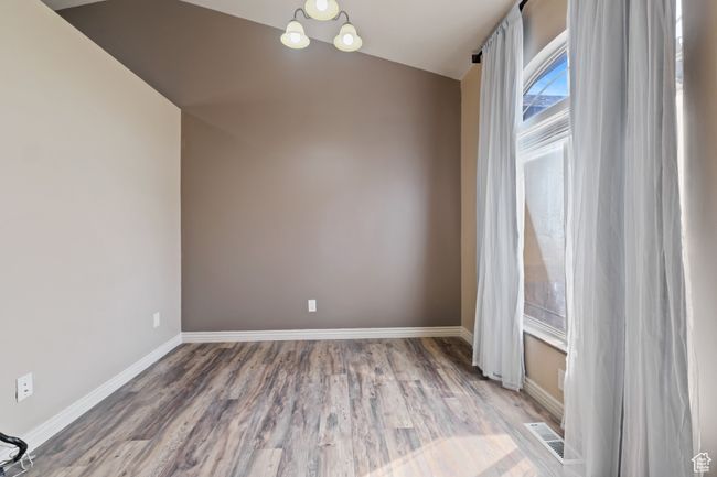 Unfurnished room featuring wood finished floors, visible vents, and baseboards | Image 34