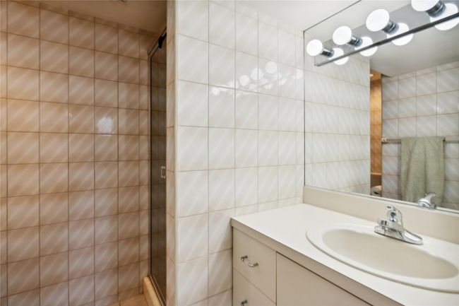 Bathroom with a stall shower, vanity, and tile walls | Image 18