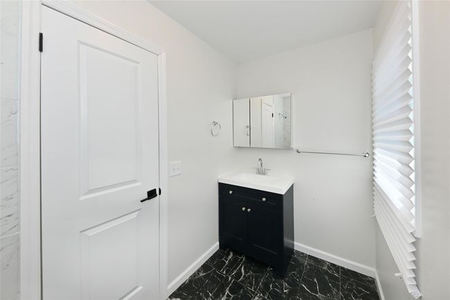 Bathroom featuring marble finish floor, vanity, and baseboards | Image 19