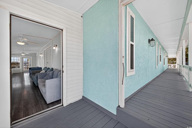Wooden deck with a ceiling fan | Image 25