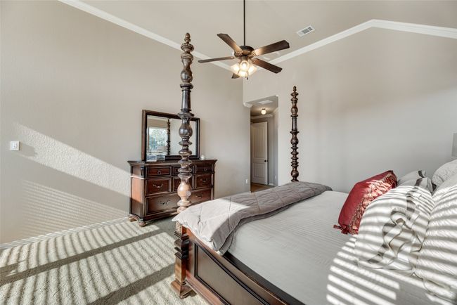 Bedroom with lofted ceiling, crown molding, and light colored carpet | Image 14
