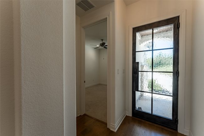 Doorway featuring dark wood-type flooring and baseboards | Image 7