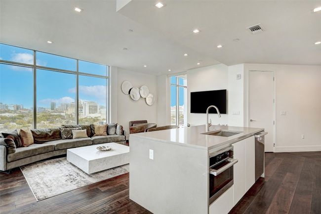 Kitchen with open floor plan, dark wood finished floors, recessed lighting, and floor to ceiling windows | Image 8