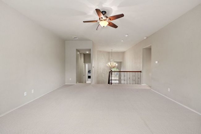 Spare room featuring a chandelier, ceiling fan, and carpet floors | Image 20