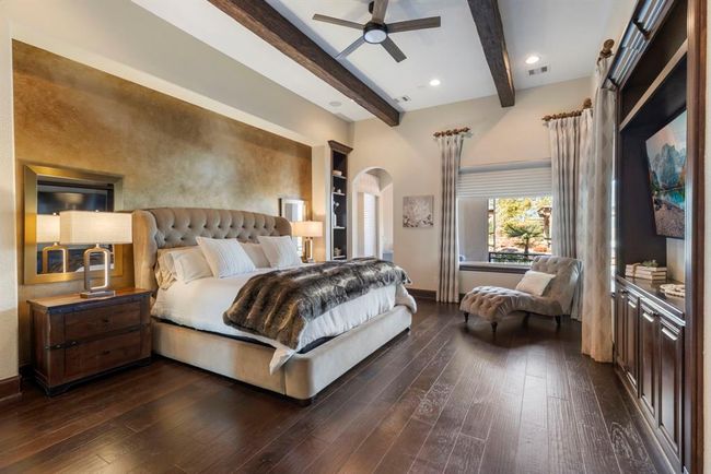 Luxurious Master Retreat: Elegant design meets comfort with rich hardwood floors, plush textures, and sophisticated accents, all bathed in natural light. | Image 16