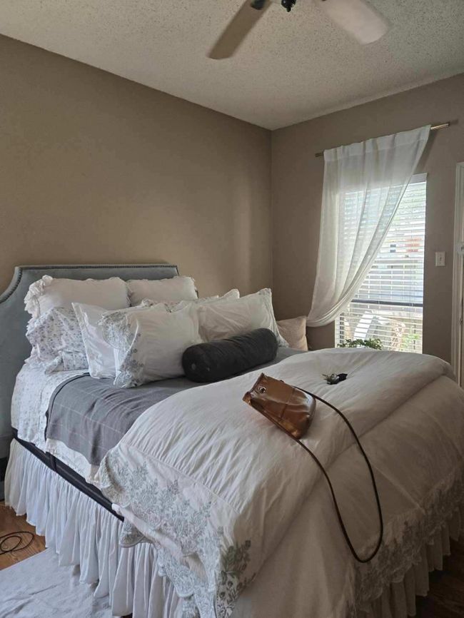 Bedroom featuring a textured ceiling, wood finished floors, and a ceiling fan | Image 9
