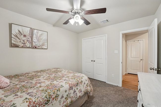 Bedroom with a closet, carpet, and ceiling fan | Image 18
