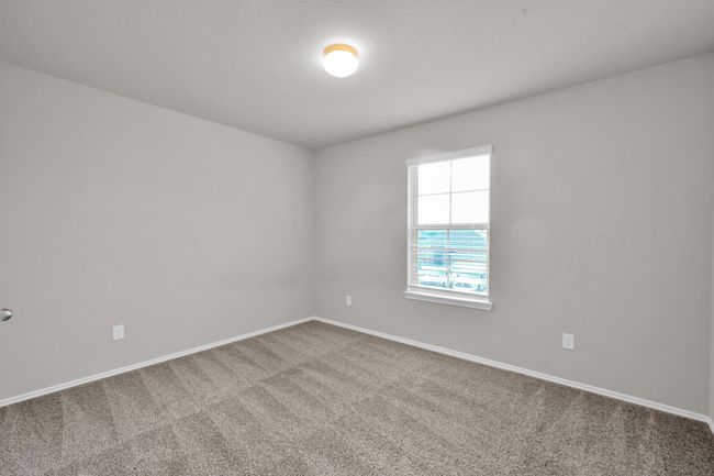 Alternate view of the fourth bedroom highlighting the window. | Image 29