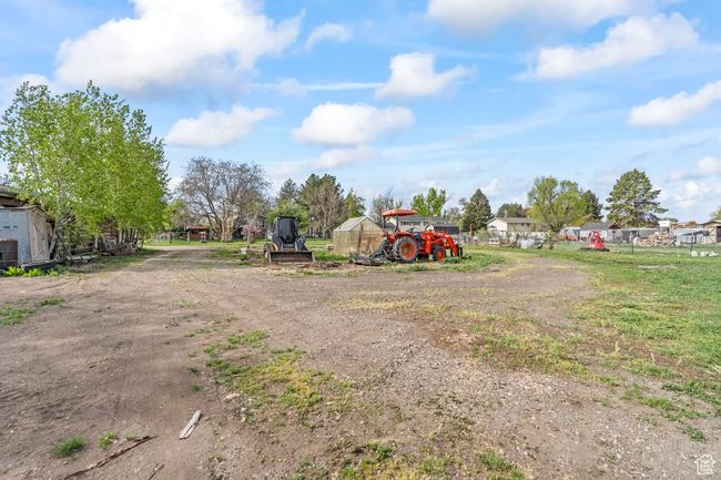 View of yard featuring an outbuilding and fence | Image 34